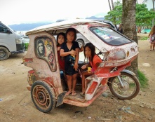 some kids in a tricycle